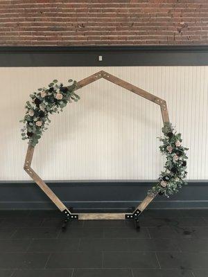 Geometric wood wedding arbor with flowers