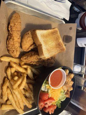 Chicken fingers , fries and salad with Texas toast.