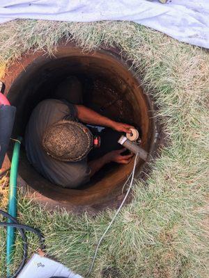 Repairing a leak in the meter vault.