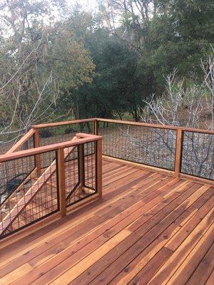 The hog wire and redwood handrail don't block the view.