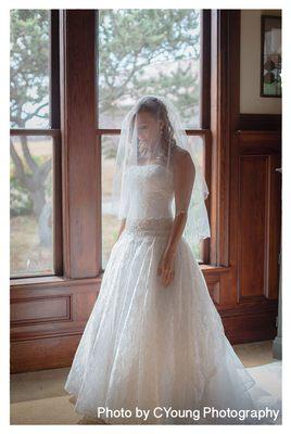 The bride takes a moment in the living room of the Victorian house before walking the aisle.