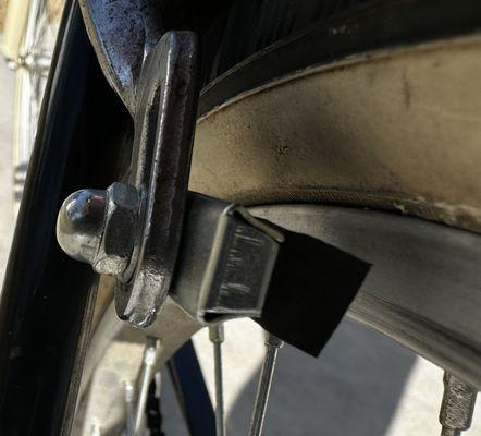 In this photo, you can see that the rubber brake pad that the "mechanic" tried to puch back in place didn't even contact the rim squarely.