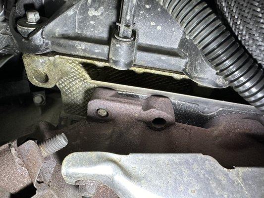 Broken manifold bolts and cracked valve cover.