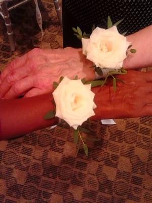 A Romanian custom.The Mother-in-Laws each wear a flower on their wrist.