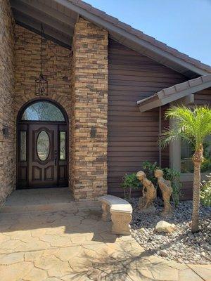 Exterior remodel. New siding, windows, stack stone and entry door.