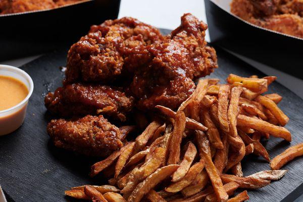 our house made BBQ Sause tossed chicken tenders and house cut fries.