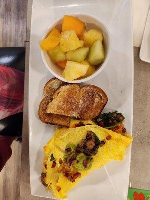 Veggie omelet, wheat toast, and fresh fruit cup