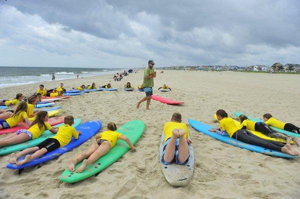 Basics are taught on the sand by expert instructors