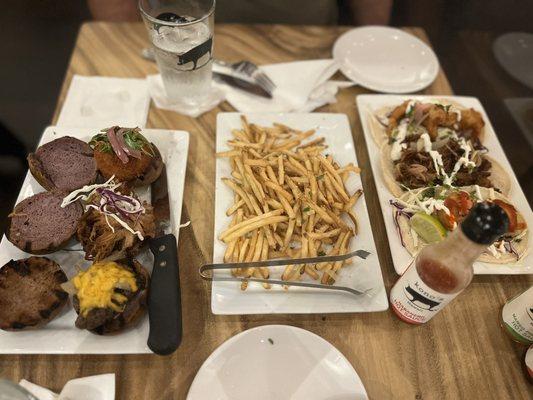 Left to right: trio sliders (burger, bbq pork, crab cake), truffle fries and street tacos (shrimp, bbq pork, fish)