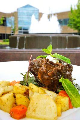 Chef's Table's Braised Oxtail: with roasted root vegetables, braised reduction sauce, wilted bitter greens, and fresh mint cream ($9.99).