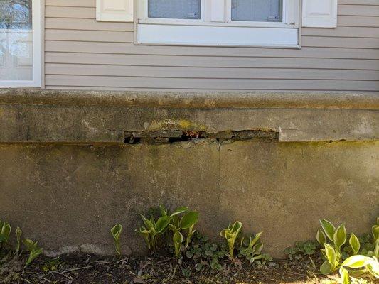 Hole in rim of front porch with exposed wood framing