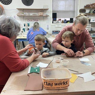 Children and adults at a hand building event.