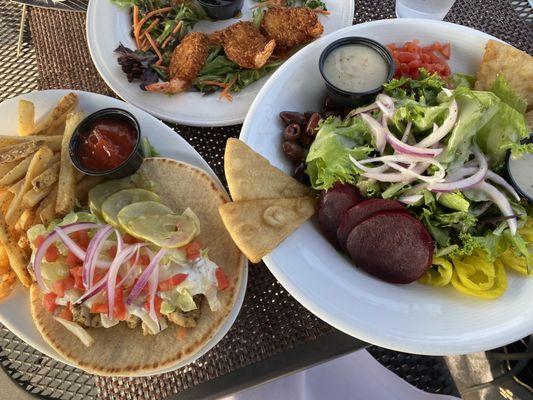 Mediterranean chicken wrap, Greek salad, and coconut shrimp.