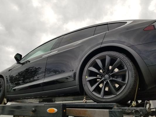 Tesla strapped down on the upper deck