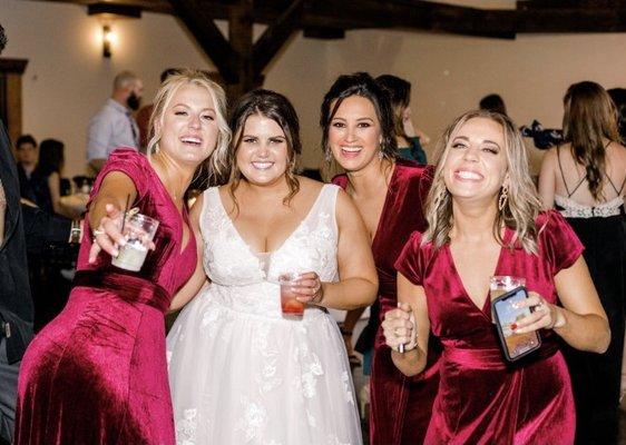 Bride and bridesmaids having fun