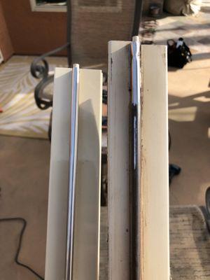 Left side is our aluminum vinyl door track, on the right is the weak plastic track the door came with that split