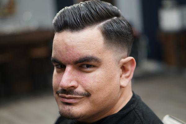 Traditional comb over with a skin fade.