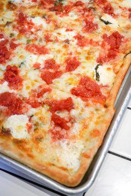 A pie of traditional Sicilian pizza