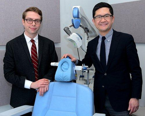 Dr. Woo and colleague with the Neurostar TMS system.