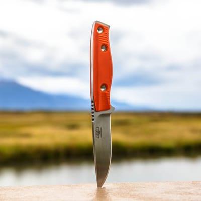 3 Dog Knife MAK. Shown in satin hand-finish, with hunter orange G10 scales. Many variations available. Handmade in Alaska.