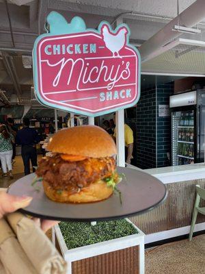 Hot chicken sandwich in front of the cute rotating sign