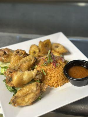 Chicken Wings and Jollof Rice with side fried Plantains and Hott sauce