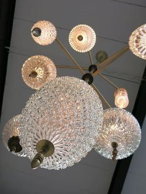 Chandelier by Michelle James using vintage glass globes on patinated brass frame.