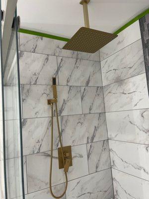 new shower installation, granite tile and gold appliances