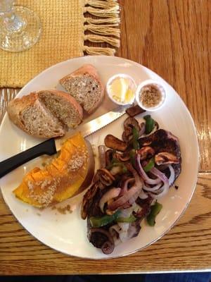 Coffee rubbed steak with sauté onion, peppers, and mushrooms. Acorn squash and bread.