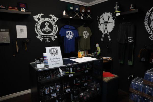 The front office including our in-house supplements for maximum performance, merch/apparel & a fridge full of pre-workout!!!