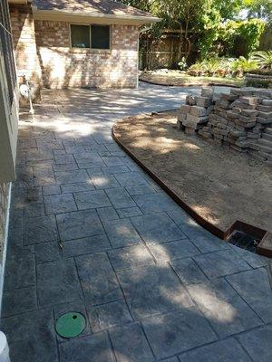 Concrete flooring is a great way to change low spots to correct drainage issues. It can also be an attractive feature in your yard!