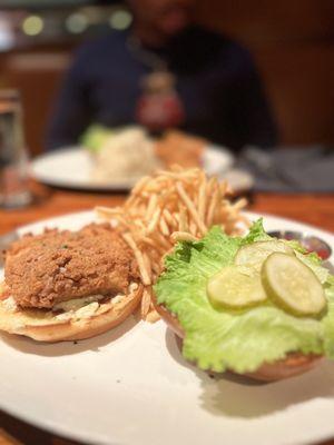 Fish sandwich with shoestring fries. Cod was accompanied with a remolaude sauce, lettuce and pickles. I believe on a potato roll.