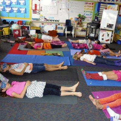 Kids relaxing in Savasana