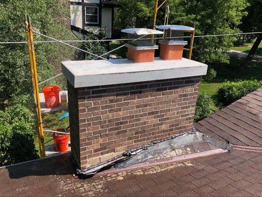 New crown poured, unused flue tiles removed, and new chimney caps installed