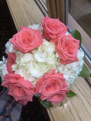 Bouquet for a Bride With White Hydrangeas and coral colored roses.