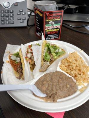 Chicken, pork, and beef tacos with rice and beans