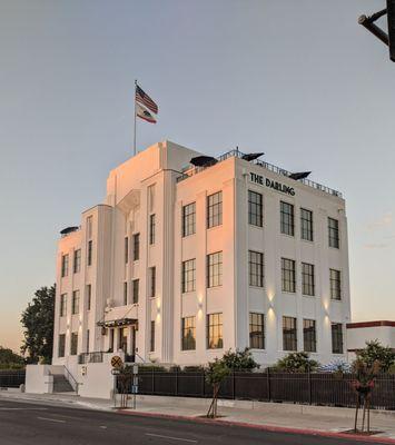 The ol' girl is catching some of the glow of the setting sun as the building lights come on