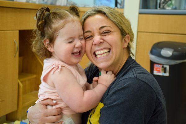 Girl and teacher smiling.