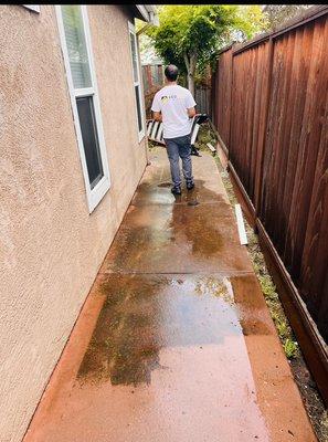 Washing the sidewalk.