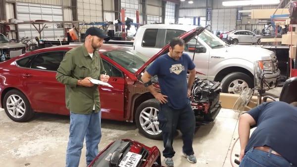 Here we have service writer Kenny, the body technician Hector, and the Production Manager Henry BLUE PRINTING or planning and...