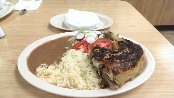 Pollo Asado con arroz y frijoles con tortillas echo a mano. Grilled chicken with rice and beans and hand palmed tortillas.