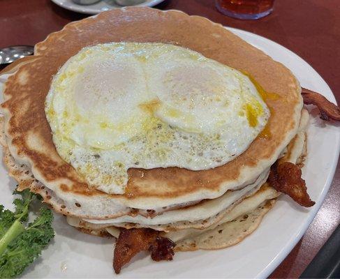 Mesa: towering pancake sandwich, three pancakes layered with two strips of bacon, two sausage patties or links and topped with two eggs!