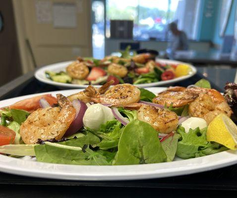 Fresh salads topped with seafood