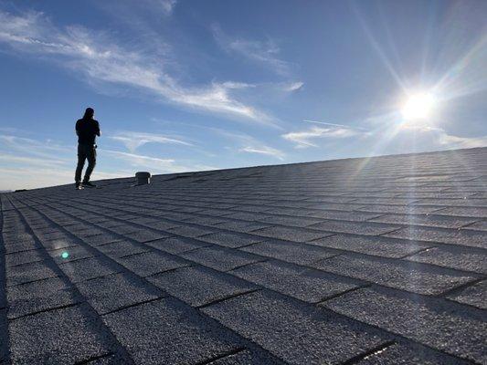 Adjuster John Morris inspecting roof damage.