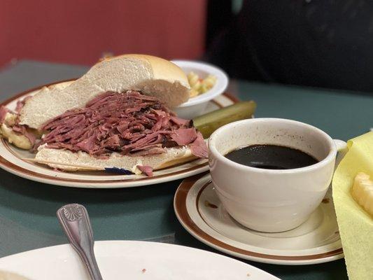 Pastrami on roll with au jus.