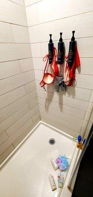 Use floor as  shelf, hang wet bathing suit with shampoo