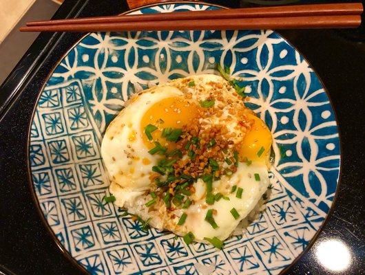 Rice egg. Topped with crispy garlic, green onion