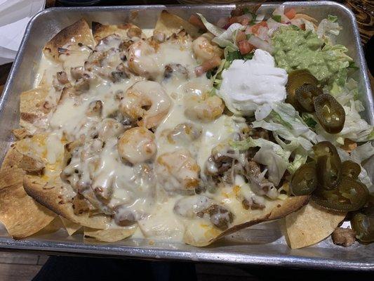 Nachos locos with toppings on side