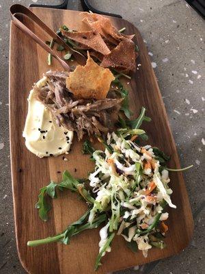 Duck confit with wonton chips and Asian slaw