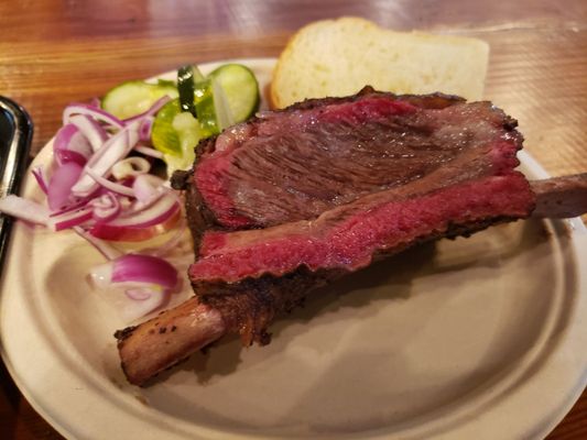 Beef rib with housemade pickles, bread and onions.